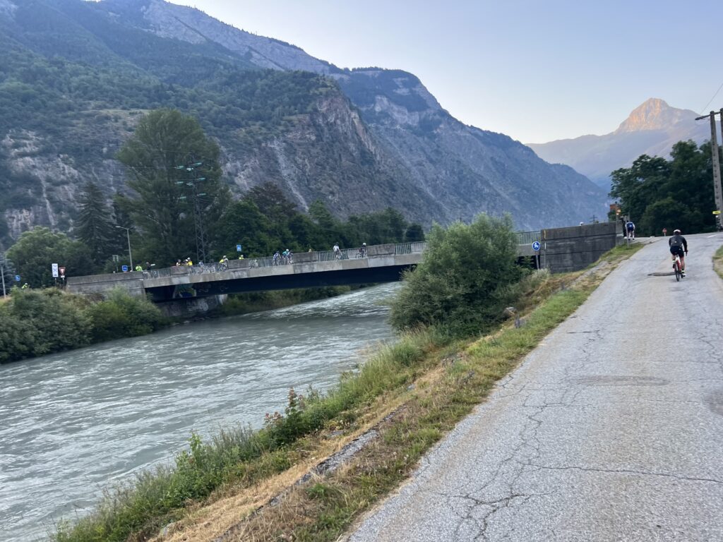 A lone cyclist by a river